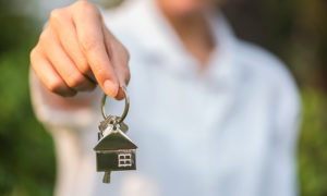 agent giving keys to new homeowners | christmas real estate marketing ideas